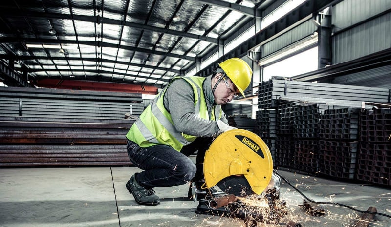 man works with DEWALT Chop Saw