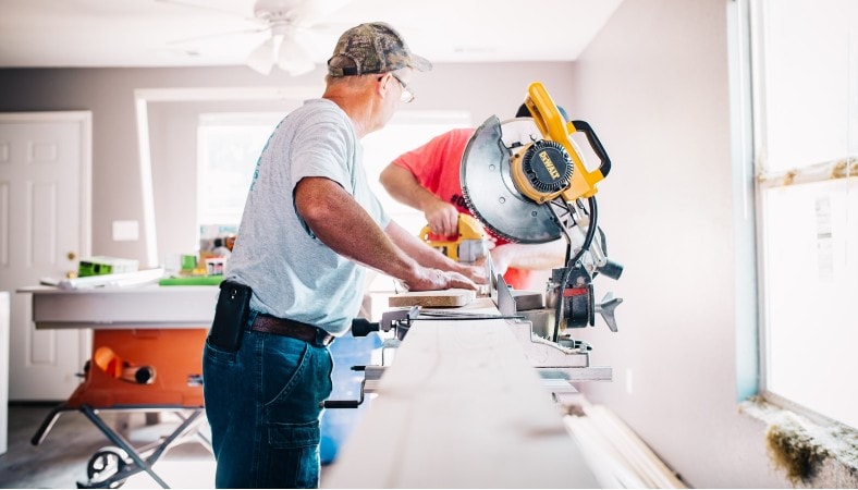 man in front of miter saw