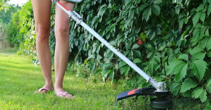 Girl mows the lawn