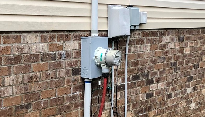 The extension cord from the generator is plugged into an outlet at home