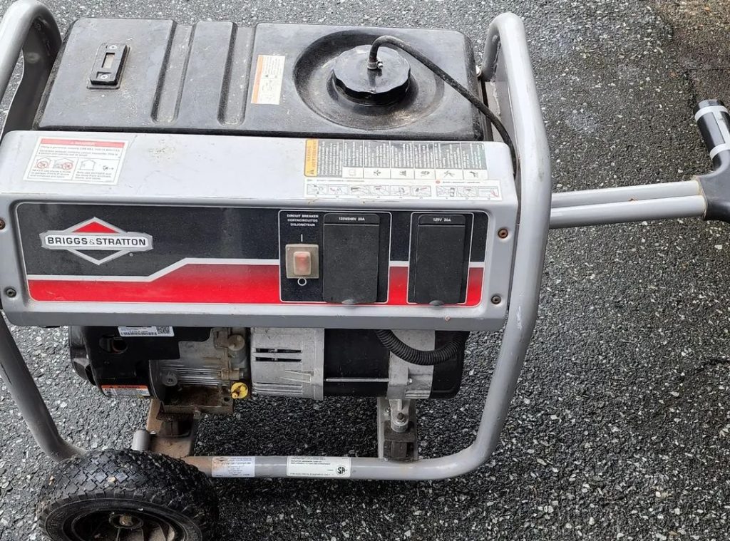 silver portable generator with wheels on asphalt