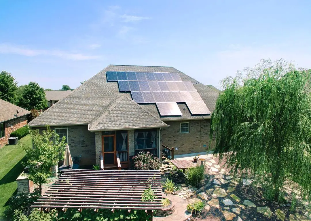 A house with solar panels on the roof on a sunny day