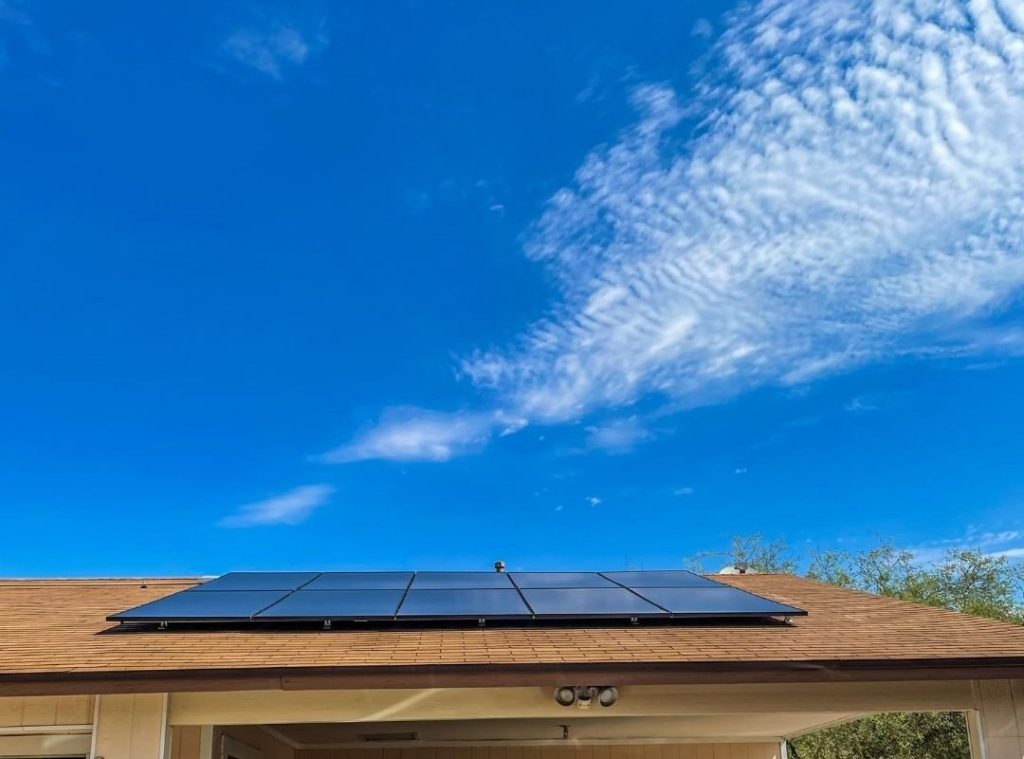 a small cloud over the roof with solar panels