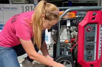 A woman in a pink T-shirt is repairing a generator