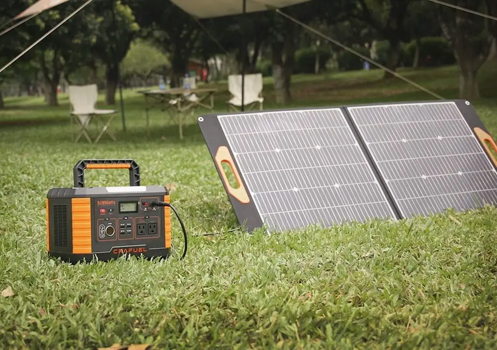 Solar generator on the grass near the camp